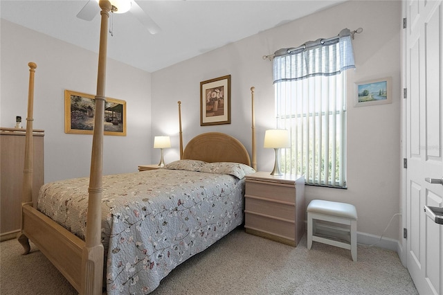 bedroom featuring ceiling fan, carpet floors, and multiple windows