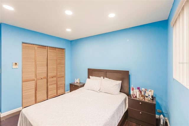 bedroom featuring dark wood-type flooring and a closet