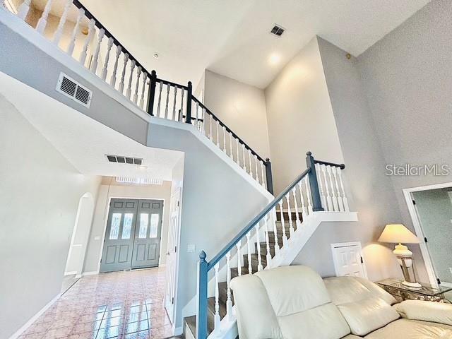 living room featuring a high ceiling