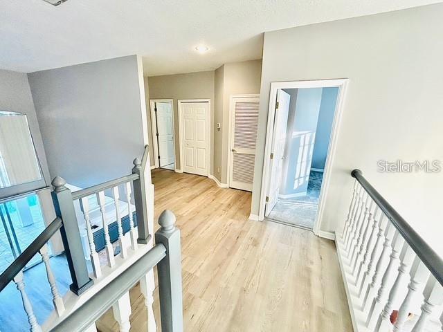 corridor with light hardwood / wood-style floors