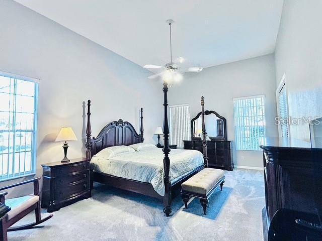 bedroom with light carpet and ceiling fan