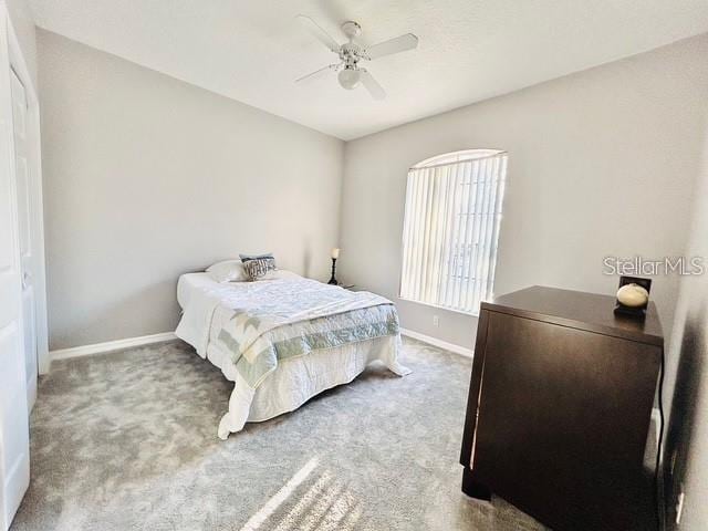 carpeted bedroom featuring ceiling fan