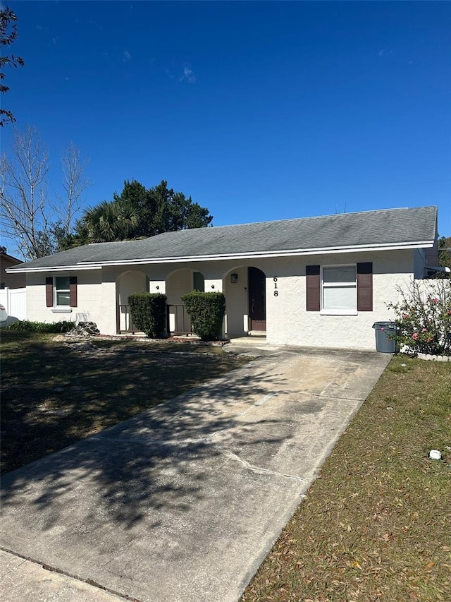 ranch-style home with a front lawn