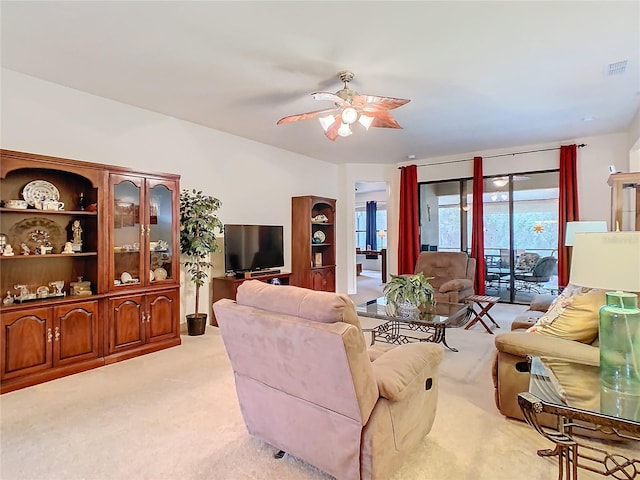 living room featuring light colored carpet and ceiling fan