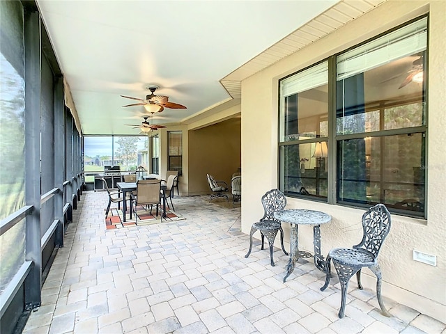 sunroom / solarium featuring ceiling fan