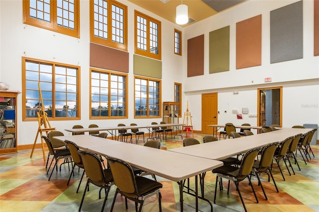 tiled dining area featuring a high ceiling