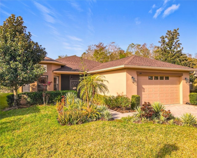 view of front of house featuring an attached garage, driveway, a front yard, and stucco siding