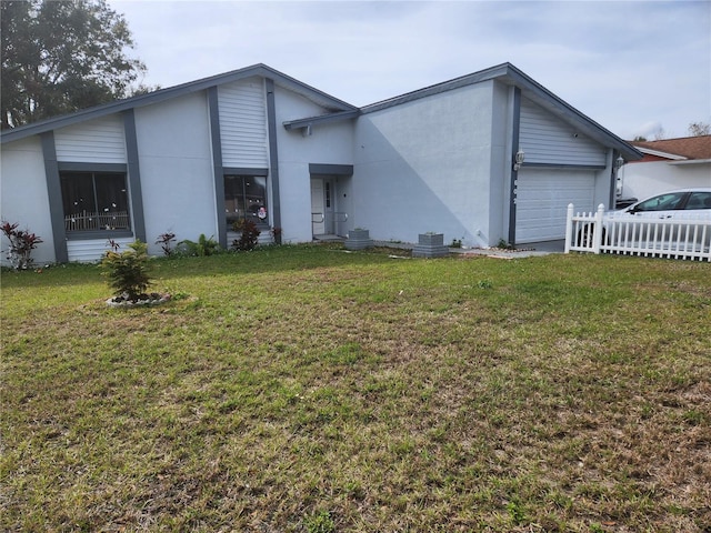 view of front facade with a garage and a front lawn