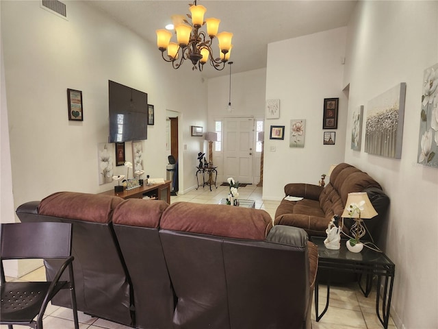 living room featuring light tile patterned flooring, a towering ceiling, and an inviting chandelier