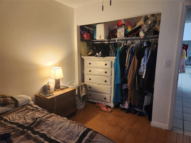 bedroom with wood-type flooring and a closet