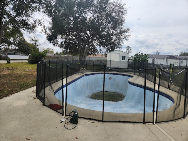 view of pool with a storage unit