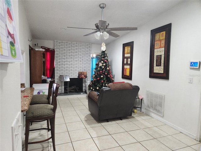 602 Caddy Dr, Kissimmee, FL 34759 - living room featuring light tile patterned floors, a brick fireplace, a ceiling fan, and visible vents