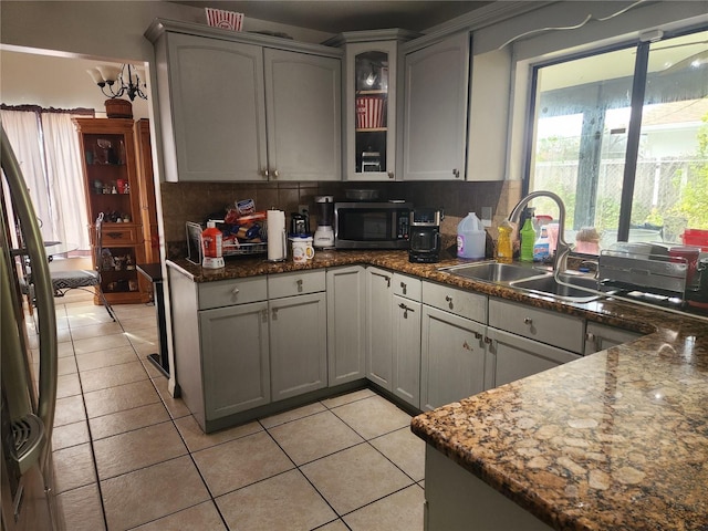 602 Caddy Dr, Kissimmee, FL 34759 - kitchen with a sink, light tile patterned flooring, decorative backsplash, and plenty of natural light