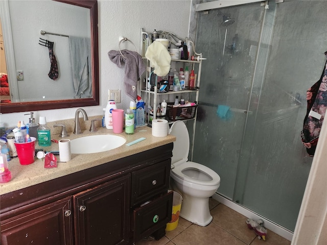 602 Caddy Dr, Kissimmee, FL 34759 - full bath with toilet, vanity, tile patterned flooring, a textured wall, and a shower stall