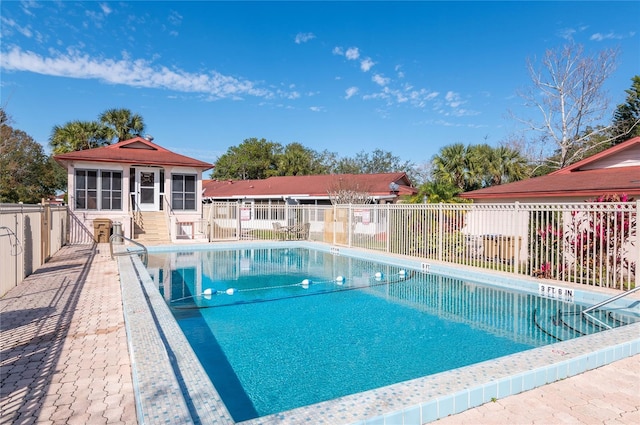 view of pool featuring an outbuilding