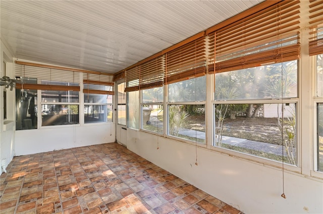 unfurnished sunroom with plenty of natural light