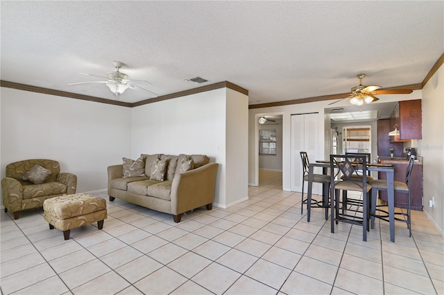 tiled living room featuring crown molding, ceiling fan, and a textured ceiling