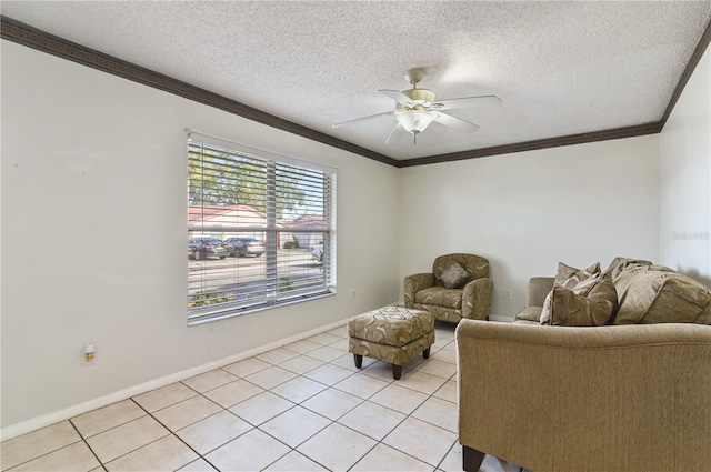 living room with ceiling fan, ornamental molding, a textured ceiling, and light tile patterned floors