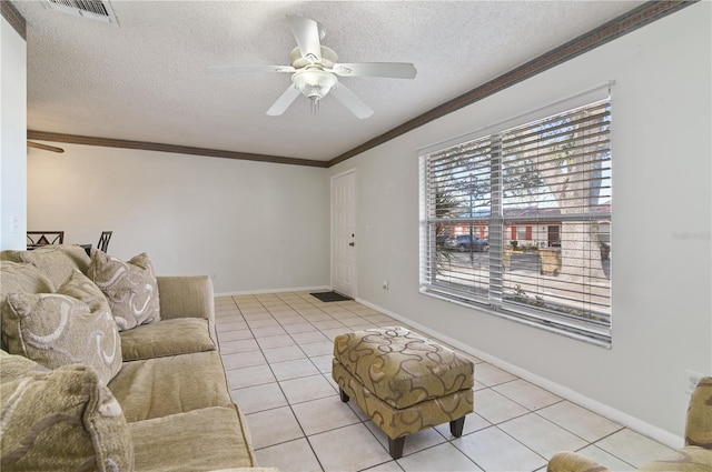 tiled living room featuring crown molding, ceiling fan, and a textured ceiling