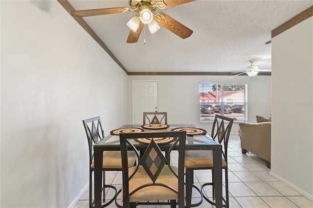 tiled dining room with crown molding, ceiling fan, and a textured ceiling