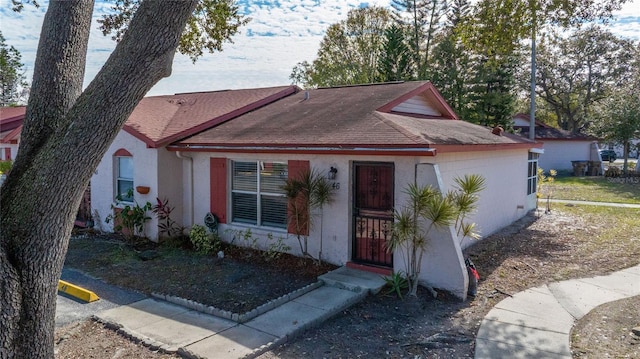 46 W Marbrisa Way, Kissimmee, FL 34743 - view of front facade featuring stucco siding and a shingled roof