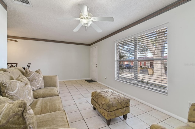 46 W Marbrisa Way, Kissimmee, FL 34743 - living room featuring a ceiling fan, ornamental molding, light tile patterned floors, and a textured ceiling