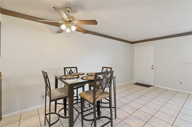 46 W Marbrisa Way, Kissimmee, FL 34743 - dining area featuring light tile patterned flooring, ceiling fan, a textured ceiling, and crown molding