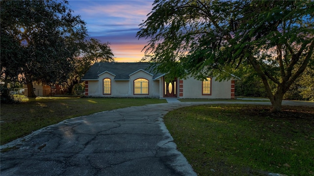 view of front of home with a yard