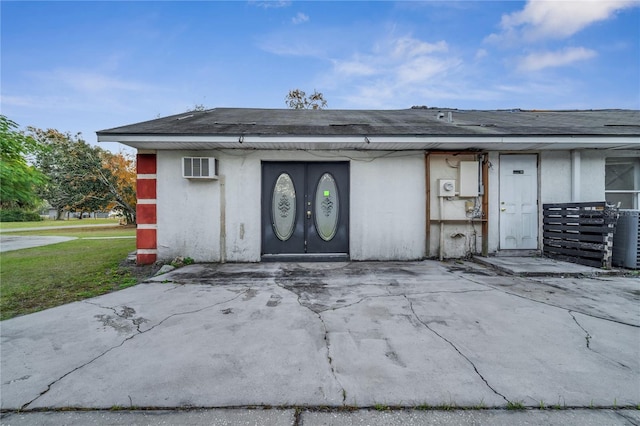 doorway to property featuring an AC wall unit