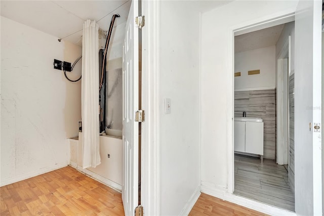 corridor with wood-type flooring