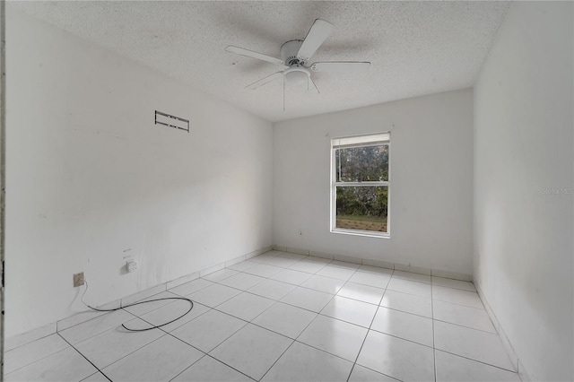 tiled spare room with ceiling fan and a textured ceiling