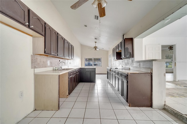 kitchen with lofted ceiling, sink, tasteful backsplash, black electric cooktop, and kitchen peninsula