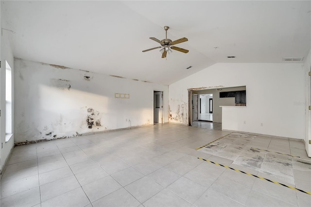 unfurnished room featuring ceiling fan, lofted ceiling, and light tile patterned floors