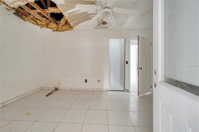 spare room featuring light tile patterned floors and ceiling fan