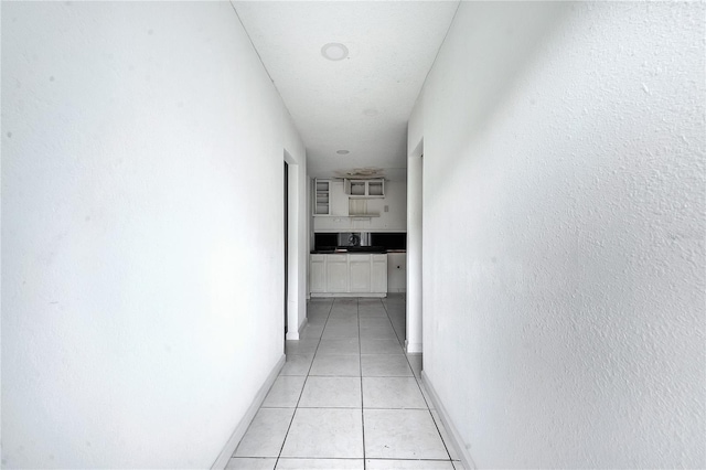 corridor featuring light tile patterned flooring