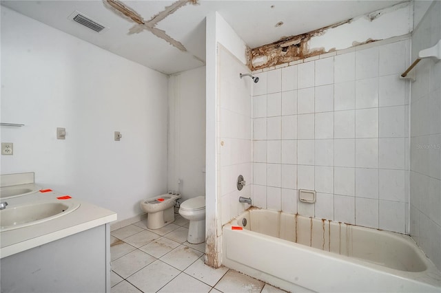 full bathroom featuring vanity, tile patterned flooring, tiled shower / bath combo, and toilet