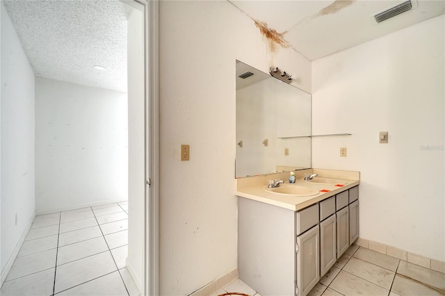 bathroom with vanity, tile patterned flooring, and a textured ceiling