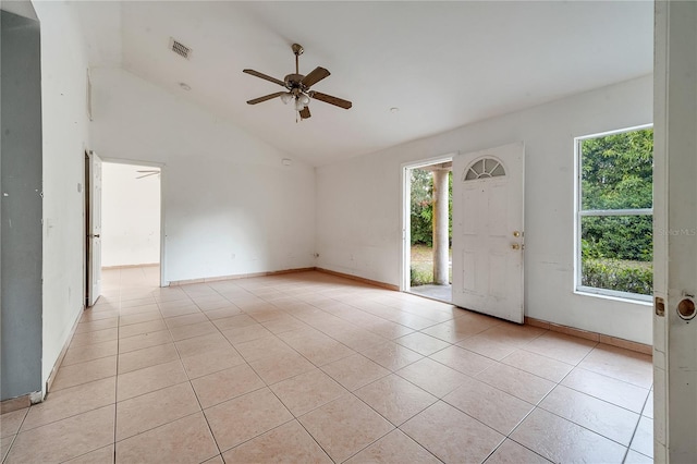 tiled entryway with ceiling fan, a healthy amount of sunlight, and high vaulted ceiling