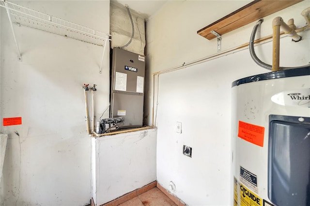 utility room featuring water heater and heating unit