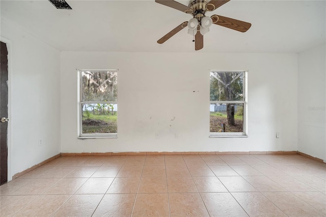 spare room with light tile patterned floors and ceiling fan