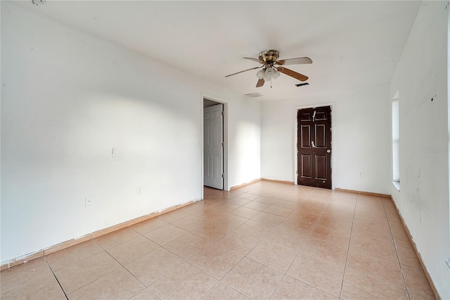 unfurnished room with light tile patterned flooring and ceiling fan