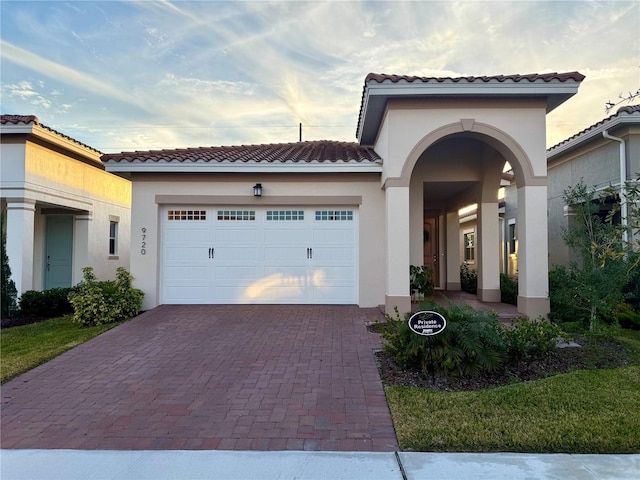 mediterranean / spanish-style home with a garage