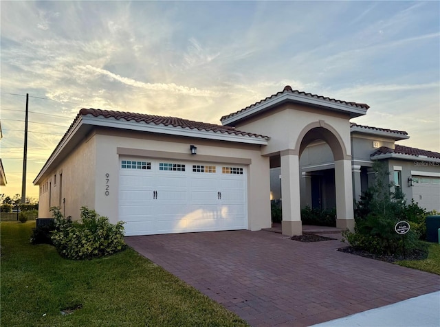 mediterranean / spanish house with a garage