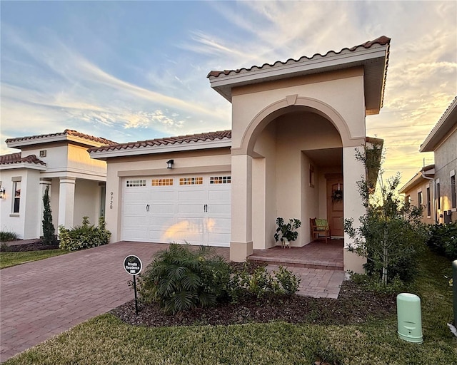 mediterranean / spanish home featuring a garage