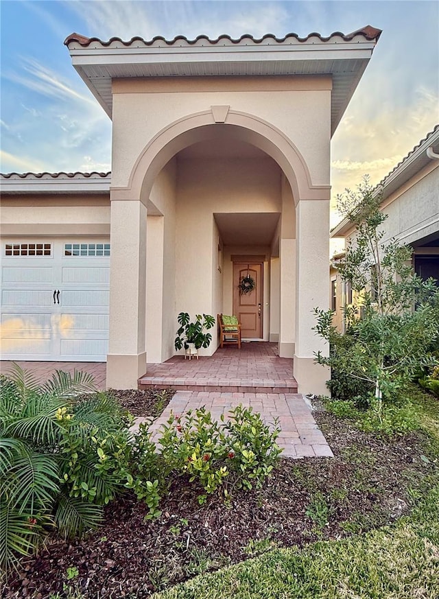 exterior entry at dusk with a garage