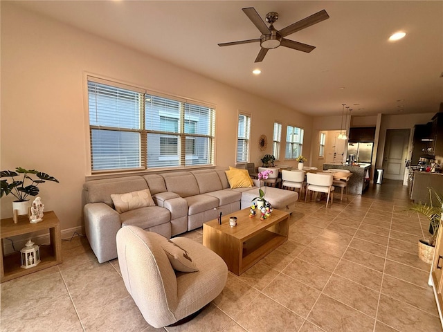 living room featuring light tile patterned floors and ceiling fan