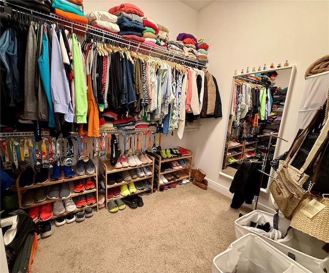 walk in closet featuring carpet floors