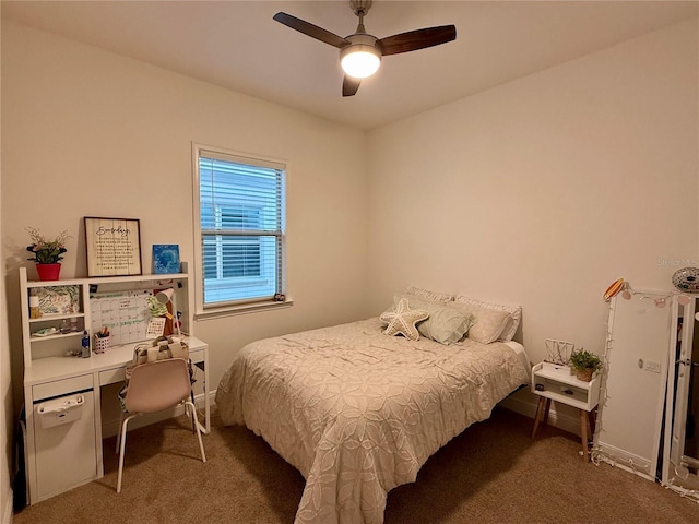 bedroom with ceiling fan and dark colored carpet