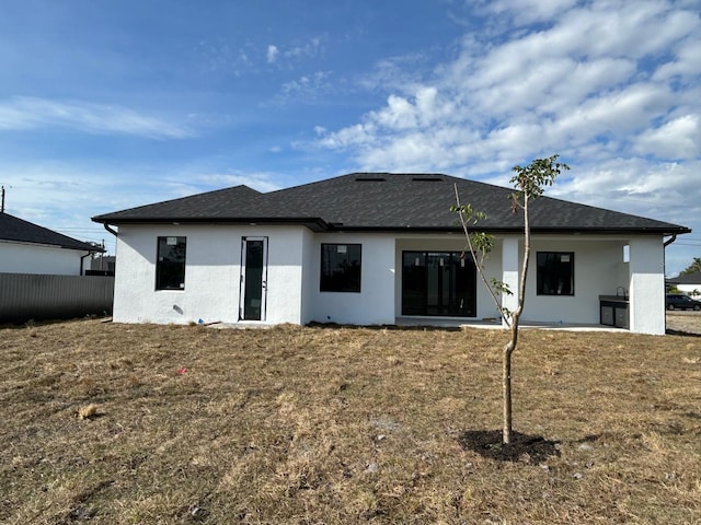 rear view of property featuring a yard