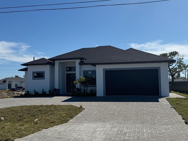 view of front of home with a garage and a front yard